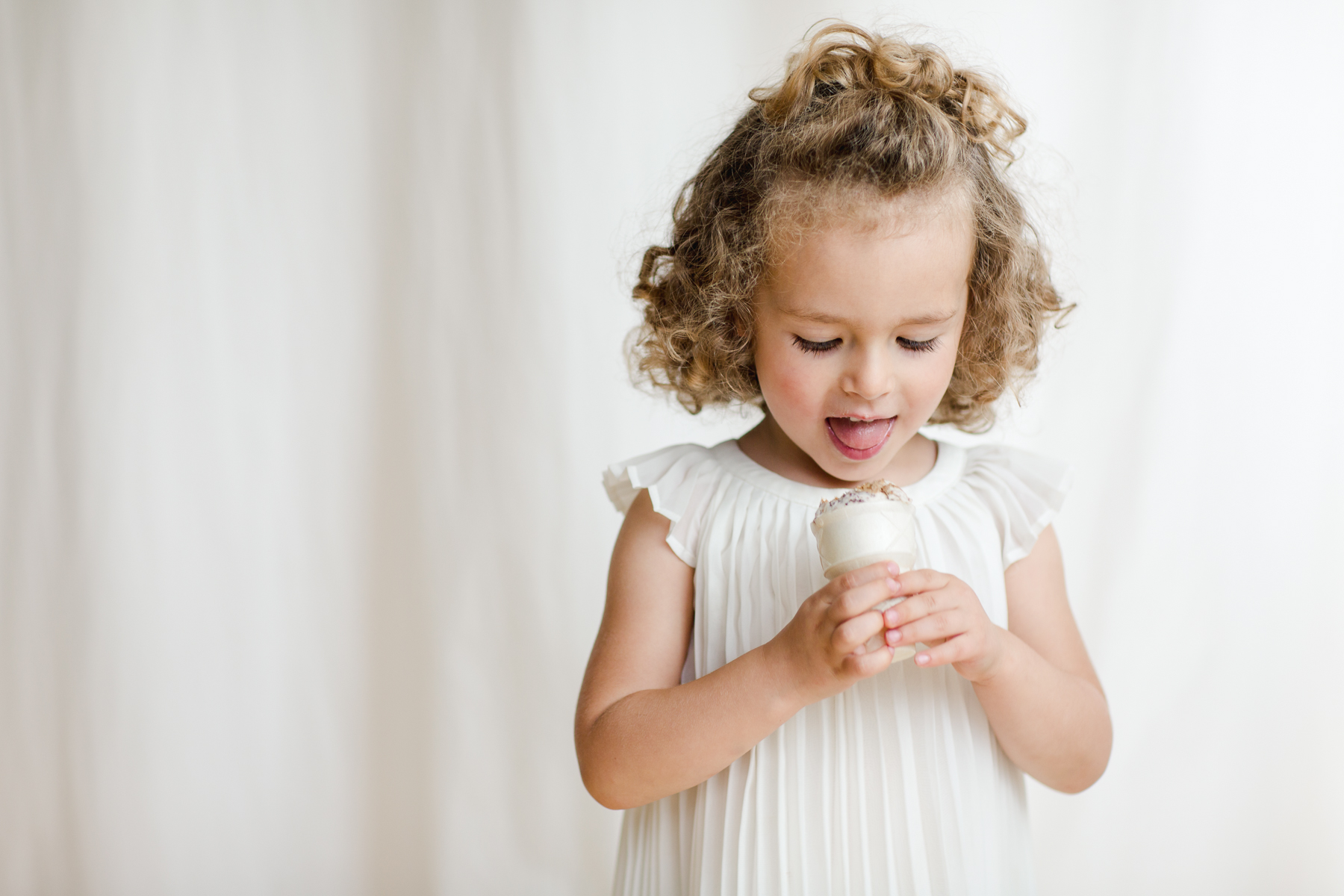 girl eats ice cream studio portrait