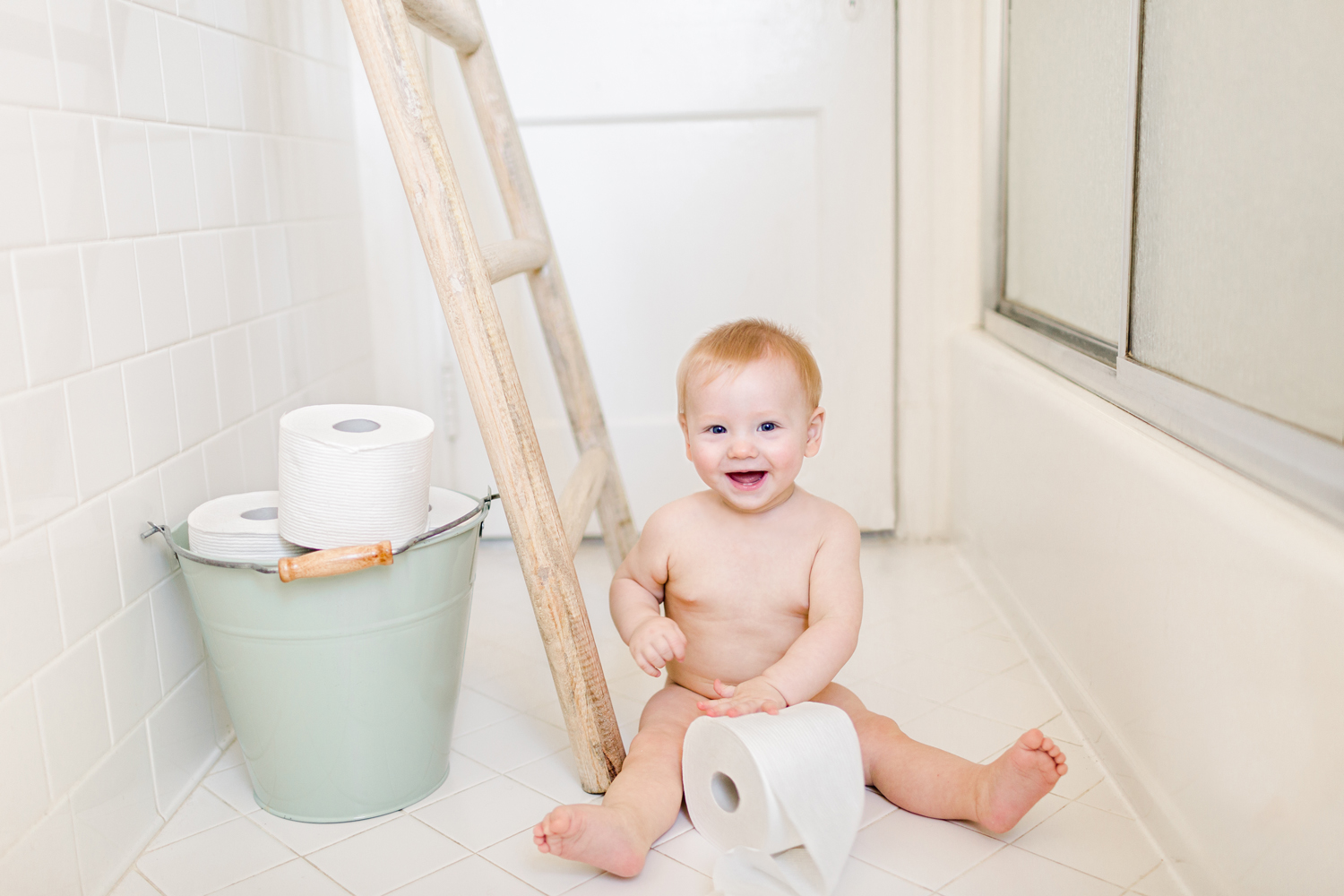baby-boy-laughs-plays-with-toilet-paper